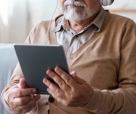 Caregiver completing GUIDE assessment on tablet.