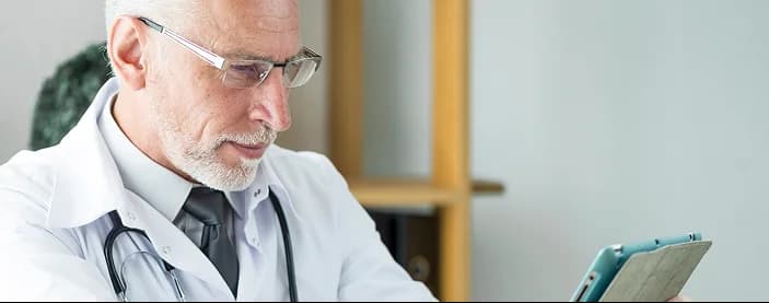 Clinician at desk supporting patient care.