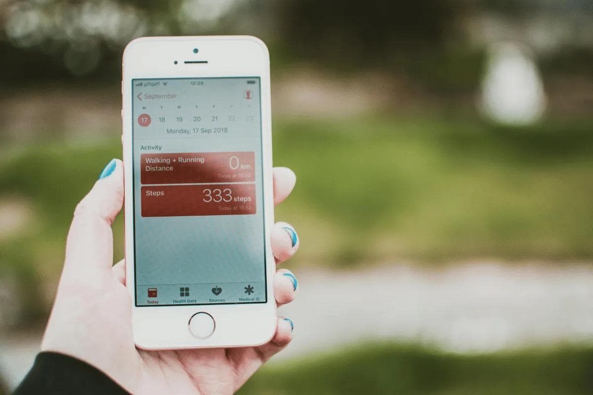 Smartphone showing step counter and fitness tracking app.